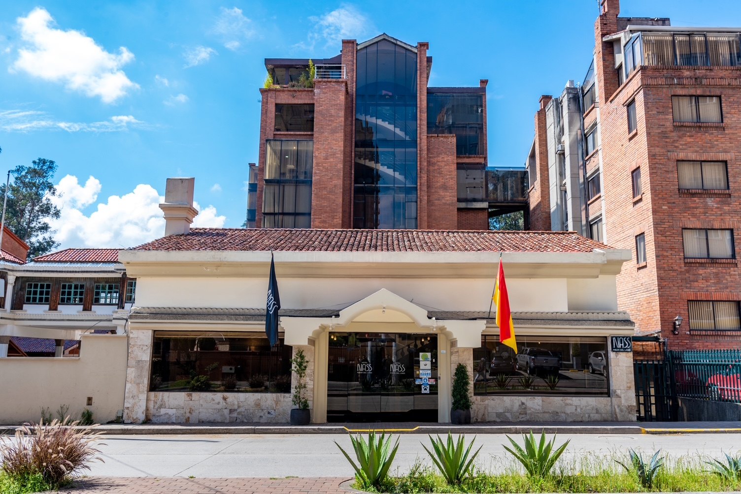 Façade of Hotel NASS Pinar del Lago on Avenida Ordoñez Lasso, Puertas del Sol district — modern brick architecture